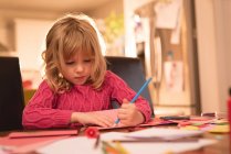 Menina adorável desenho em papel em casa — Fotografia de Stock
