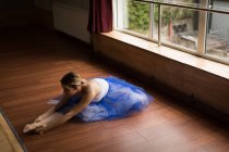 Ballerina practicing on wooden floor in studio — Stock Photo