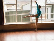 Graceful ballerina practice arabesque ballet position in studio — Stock Photo