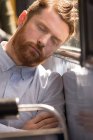Крупный план мужского пригородного сна во время путешествия в современном автобусе — стоковое фото