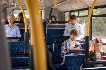 Commuters travelling in modern bus — Stock Photo