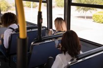 Vista traseira dos passageiros que viajam em ônibus moderno — Fotografia de Stock