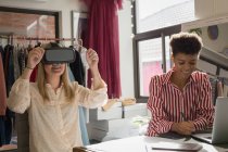 Fashion designers using virtual reality headset and graphic tablet in fashion studio — Stock Photo