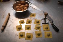 Raw pasta arranged in worktop at bakery — Stock Photo