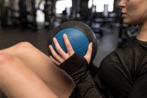 Close-up of woman doing oblique exercise in fitness studio — Stock Photo