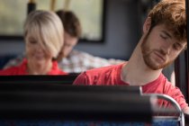 Male commuter sleeping while travelling in modern bus — Stock Photo