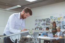 Executive working on drafting table in office — Stock Photo