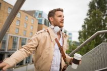 Smart man walking up stairs in city — Stock Photo