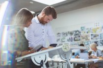 Executives working on drafting table in office — Stock Photo