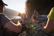 Group of friends camping near riverside — Stock Photo