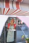Female waitress standing in food truck — Stock Photo