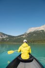 Rear view of man boating in river in mountains — Stock Photo