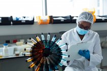 Жіночий вчений пише на кишені в лабораторії — стокове фото