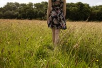Mid section of woman walking in the field — Stock Photo