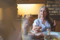 Senior couple interacting with each other on dining table at home — Stock Photo