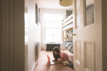 Young girl using laptop in bedroom at home — Stock Photo