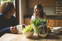 Mother and daughter interacting with each other at home — Stock Photo