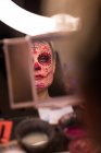 Woman dressed up for halloween admiring herself in mirror — Stock Photo