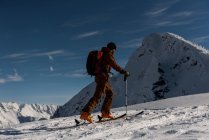 Чоловічий гірськолижник, що йде на засніженій горі взимку — стокове фото