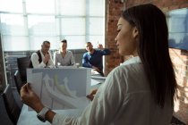 Executives discussing over graph chart in office — Stock Photo
