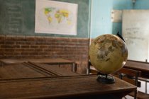 Globe in the empty classroom at school — Stock Photo
