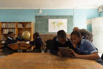 Studenti che utilizzano tablet digitale in classe a scuola — Foto stock