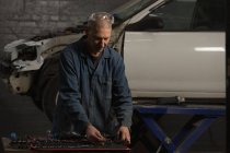 Meccanico maschio strumenti di selezione in garage — Foto stock
