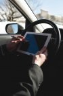 Mann nutzt im Winter digitales Tablet im Auto — Stockfoto