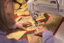 Mujer cose la ropa en la máquina de coser en casa - foto de stock