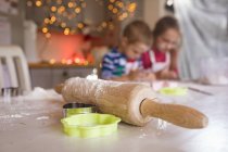 Rolling pin and cookie cutter in the kitchen during Christmas — Stock Photo
