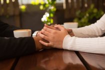 Close-up of couple holding hand in cafe — Stock Photo