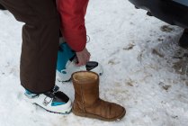 Low section of senior woman wearing ski boot — Stock Photo