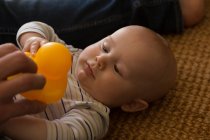 Father and baby boy playing with toy in living room at home — Stock Photo