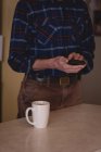 Mid section of senior man using mobile phone at home — Stock Photo