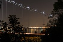 Modern suspension bridge with light trail — Stock Photo