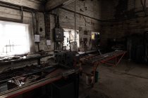 Металлические инструменты и оборудование в пустой мастерской — стоковое фото