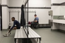 Two disabled athlete relaxing together in changing room — Stock Photo