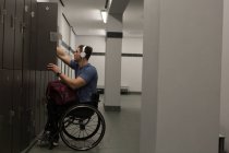 Disabled man listening music on headphones in changing room — Stock Photo