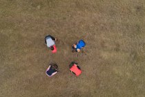 Overhead of group of people exercising on field — Stock Photo
