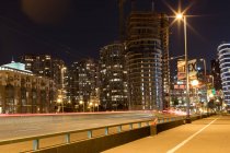 Modern downtown with light trail — Stock Photo