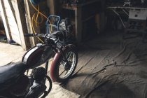 Motorbike standing in repair garage — Stock Photo