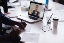 Uomini d'affari che tengono una riunione in videoconferenza in ufficio — Foto stock