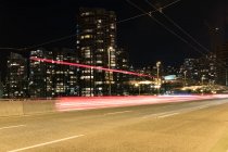 Modern downtown with light trail — Stock Photo