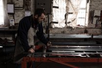 Attentive blacksmith working in workshop — Stock Photo