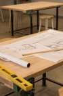 Blueprints and instruments on table in workshop — Stock Photo