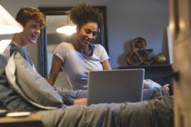Casal usando laptop no quarto em casa — Fotografia de Stock
