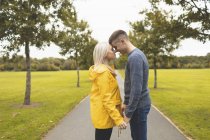 Romantic couple embracing in park — Stock Photo
