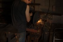 Metallschmiedin mit Metallschneidemaschine in Fabrik — Stockfoto