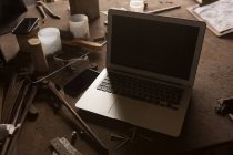 Close-up of laptop in metalsmith factory — Stock Photo