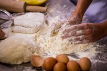 Close-up of chef preparing dough on worktop — Stock Photo